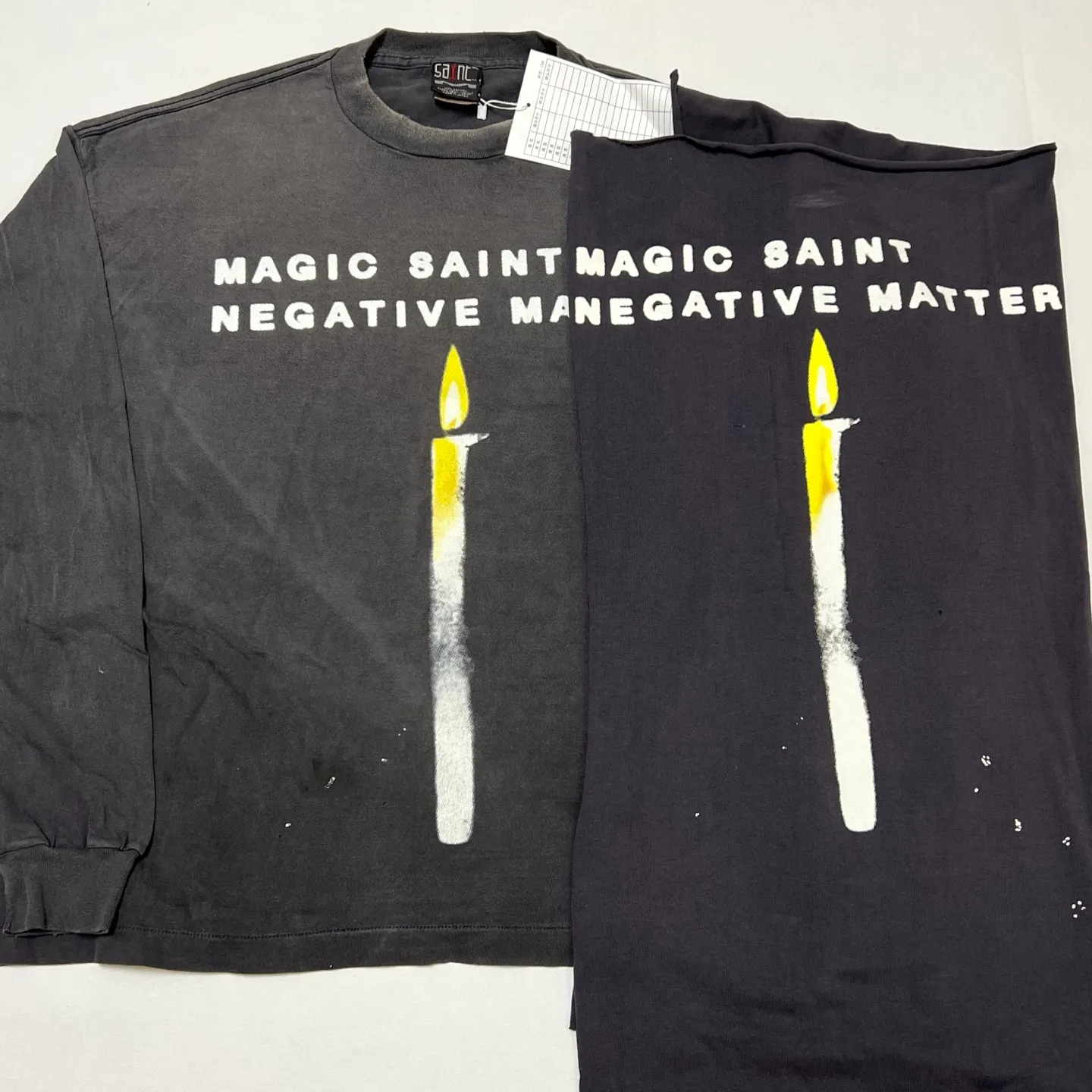 Printing proofing SAINT Mxxxxxx CANDLE LS TEE/BLK Slogan candle distressed long-sleeved TEE Little angel short sleeves on the back Washed black S-XL Original consistent Cylindrical side seam OE yarn fabric Garment dyeing Faded by heavy washes Faded by plaster on bust Correct alignment Original consistent main mark/wash mark/cherub anti-counterfeiting mark Original level printing restoration